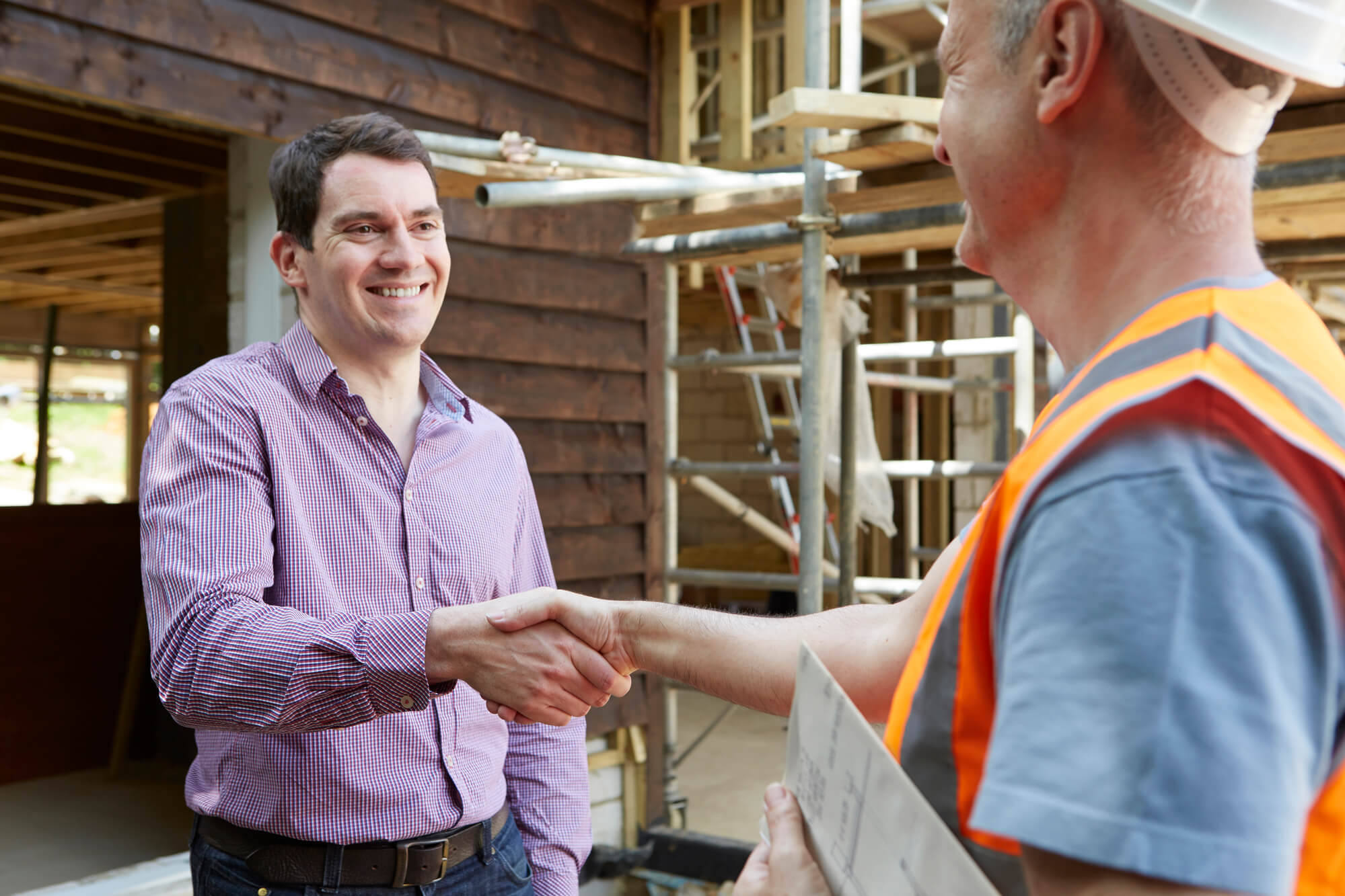 builders shaking hand with a customer
