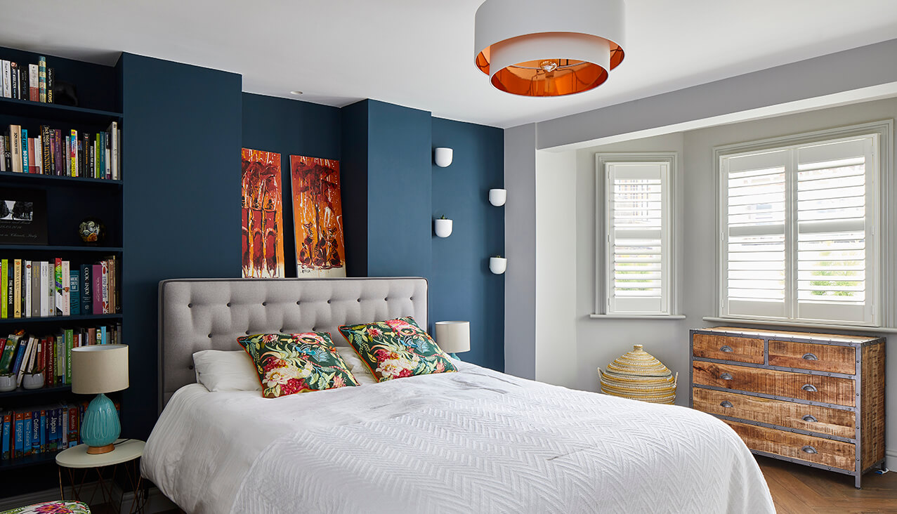 blue bedroom with bookcase