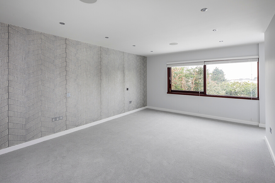 empty large grey room with brown windows
