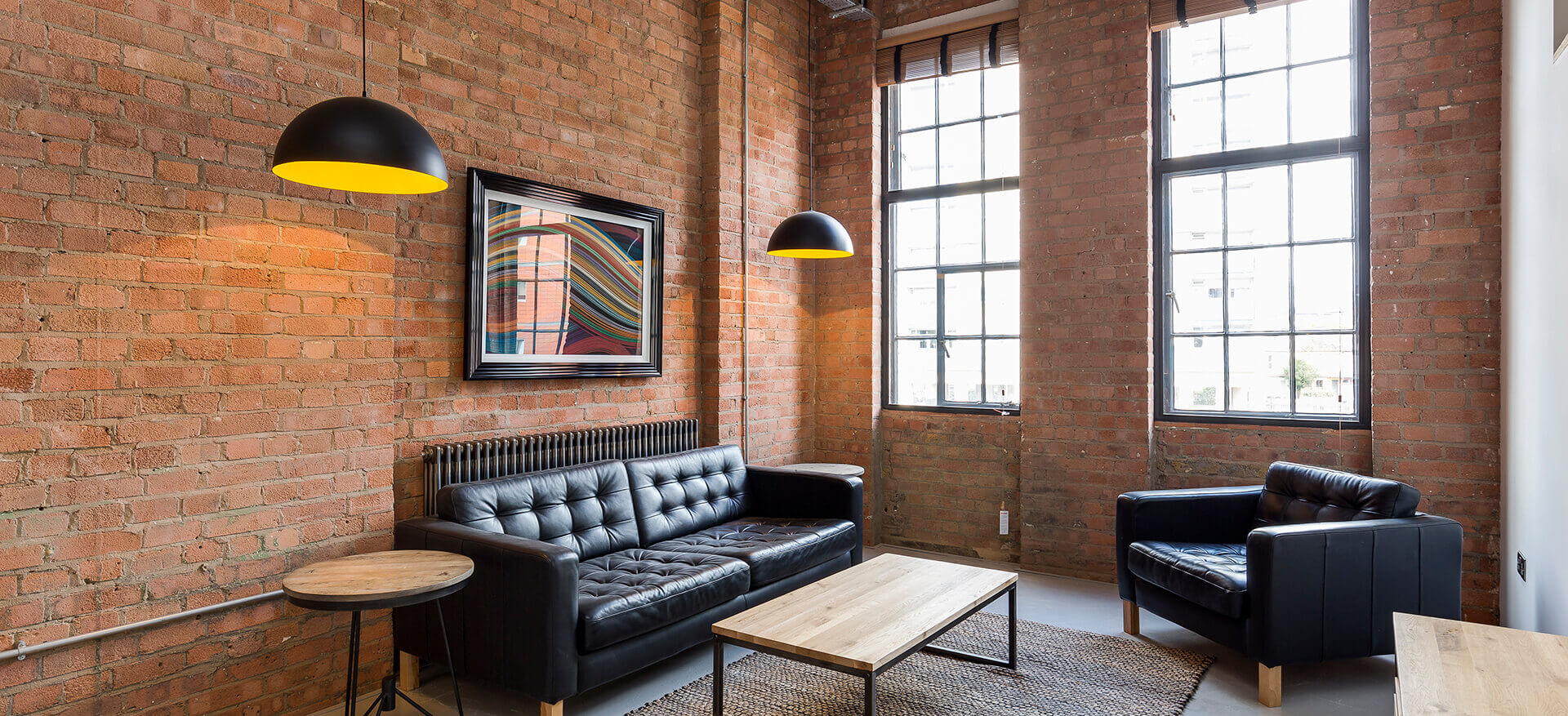 Large room with exposed red brick wall