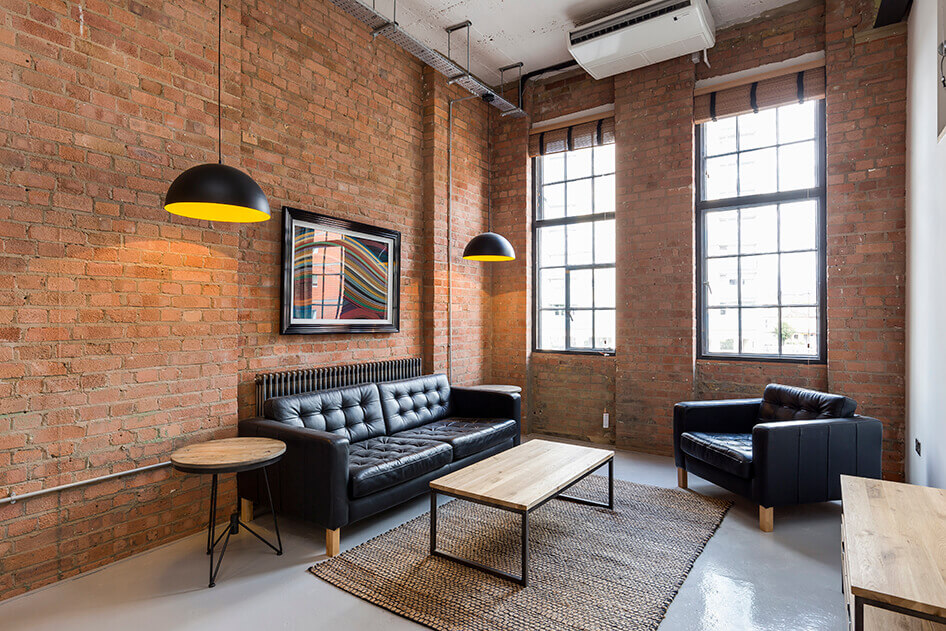 living room with brick wall