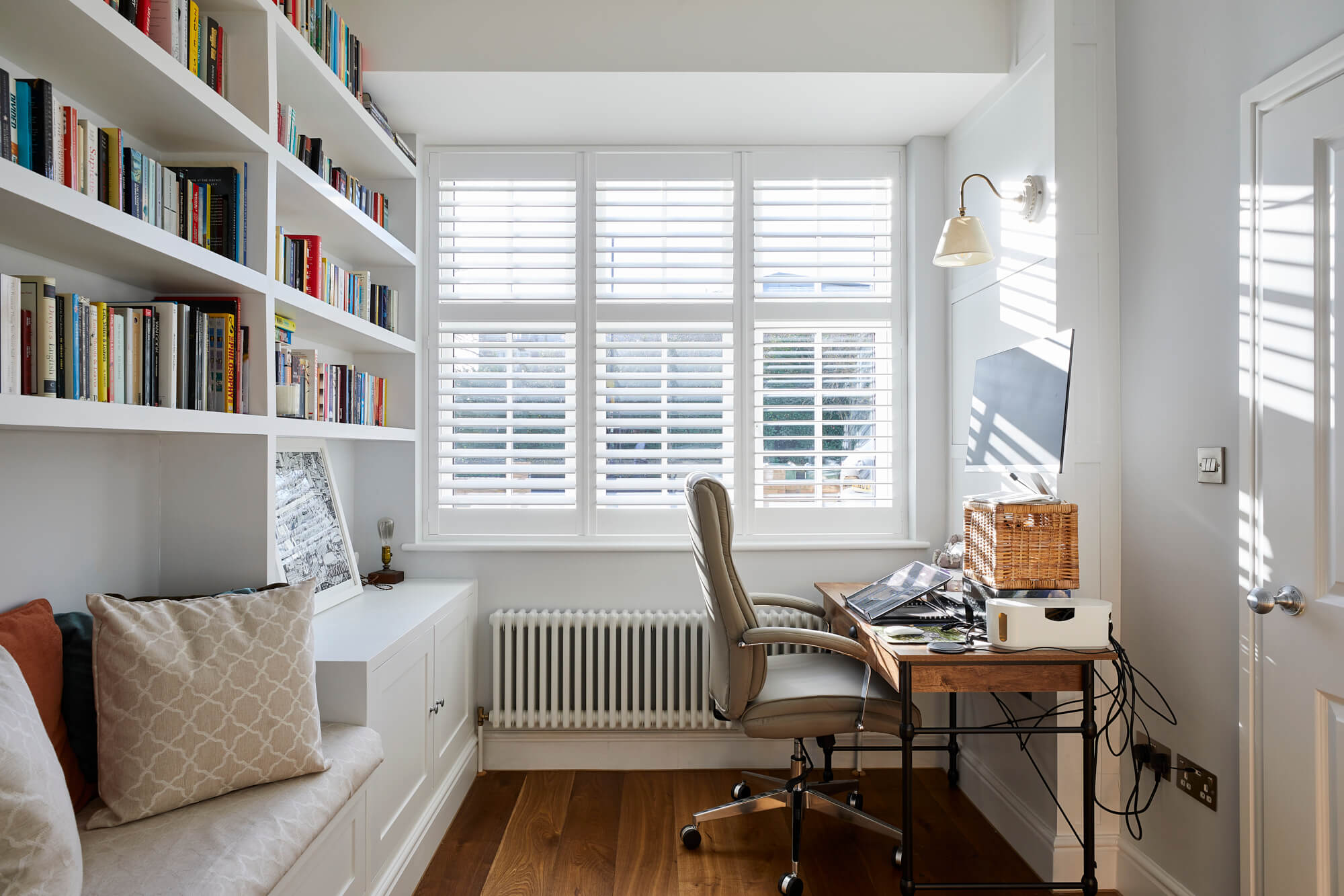 small home office with a chair,desk and bespoke inbuilt bookshelf