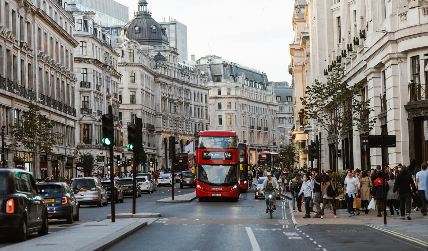 High street in London with red buss on the road