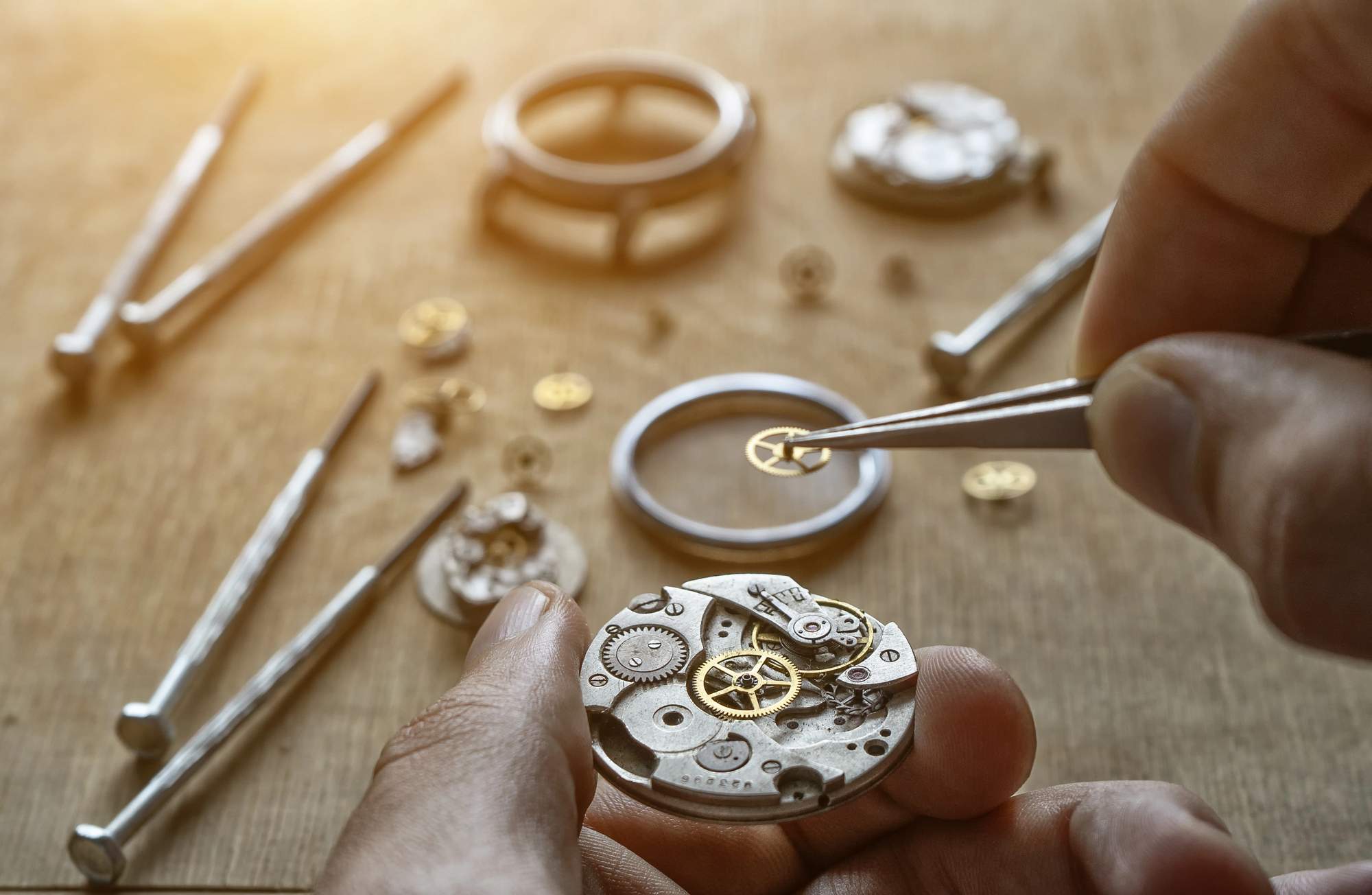Close up view of a man's hand working on workbench