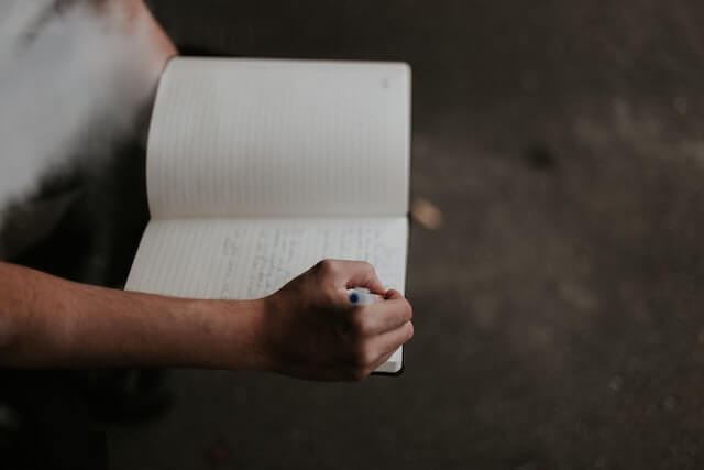 writing a song by hand in notebook