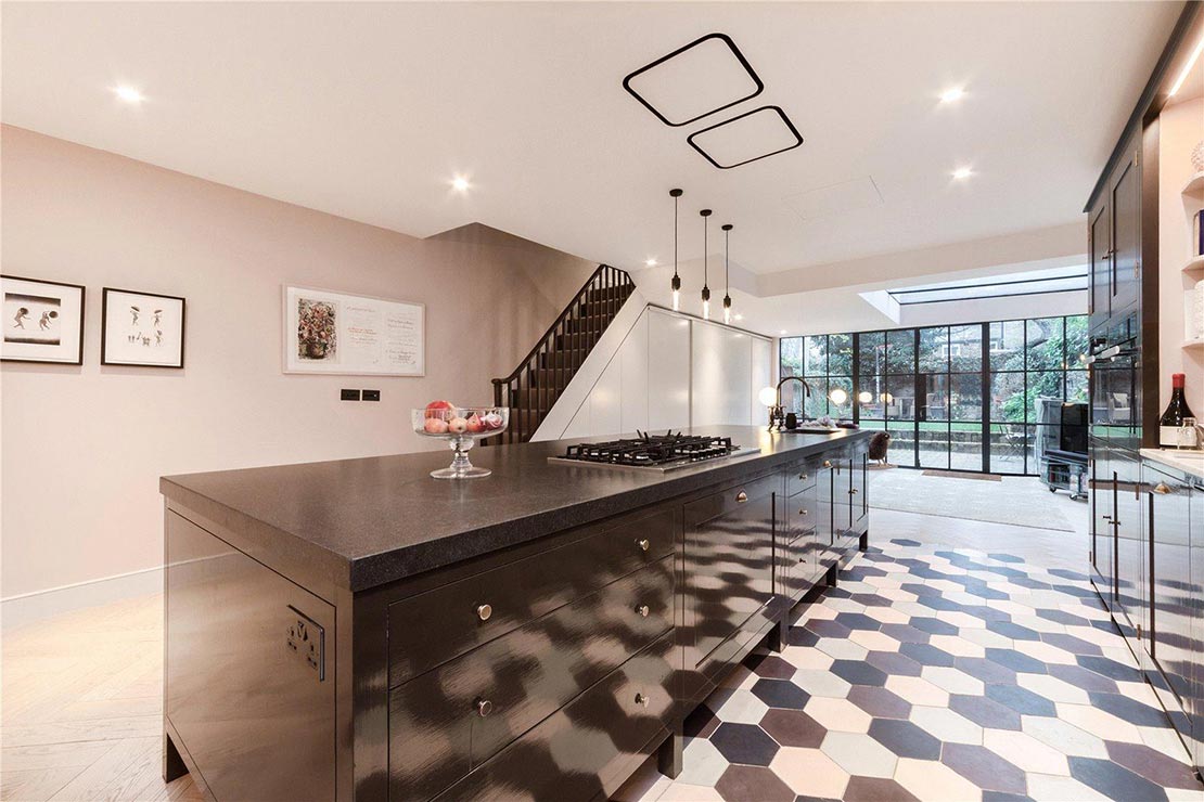 brown kitchen island with marble top and wooden cabinets near Aberdeen Road in London