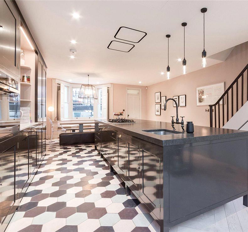 hexagonal tiled modern kitchen with brown kitchen island with sink and gas cook top