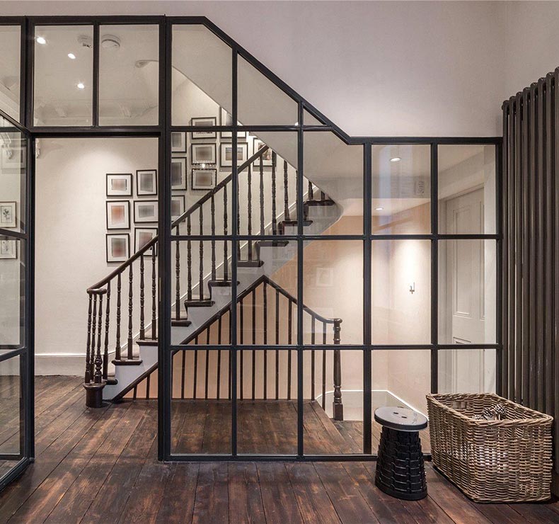 black paned glass window wall and wooden flooring