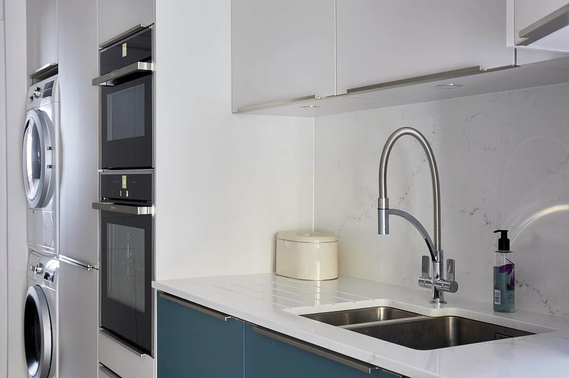 sink in a kitchen and built in washing machine