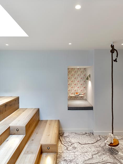 nook with skylight, white walls and wooden stairs