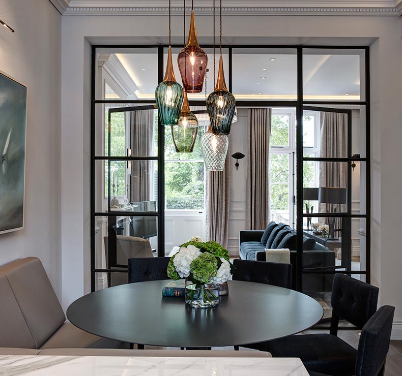 modern dining room with round table and black chairs 