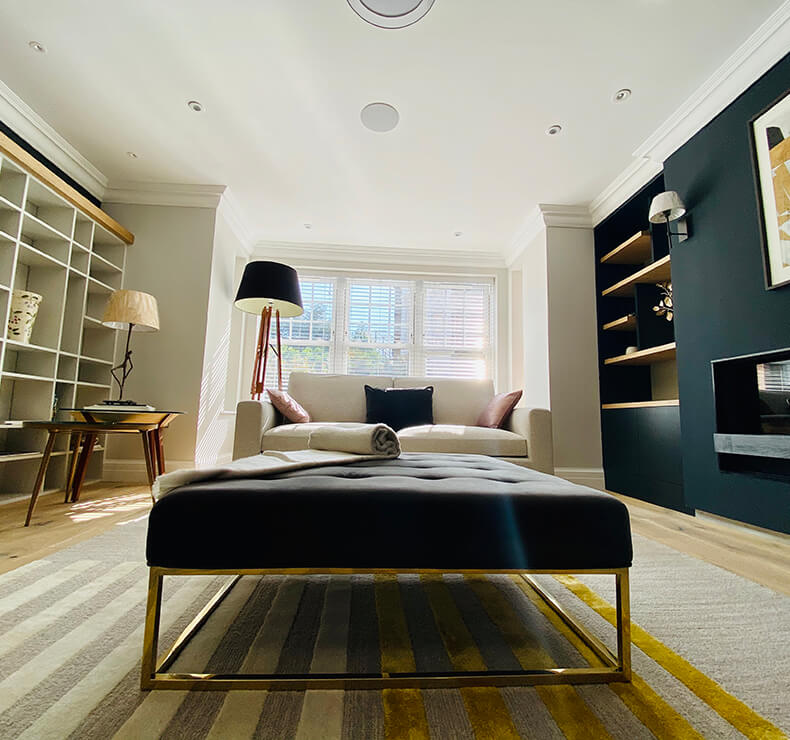 lounge room with white ceiling, louvre blinds and display case