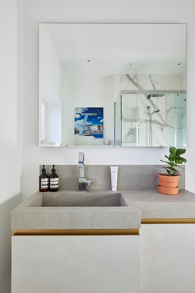 modern grey bathroom sink with white cabinet and large mirror