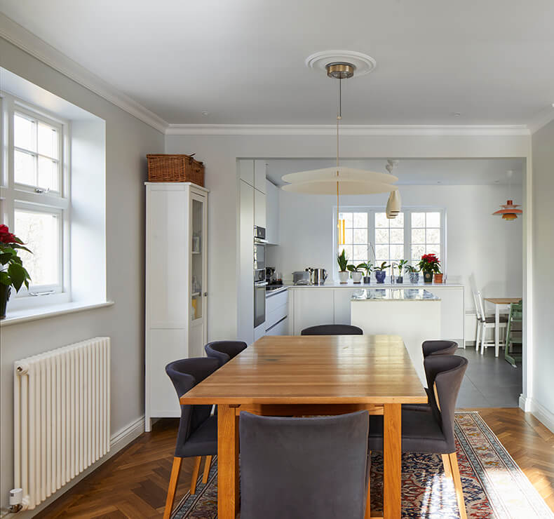 open plan kitchen and dining room with modern wooden and black dining set
