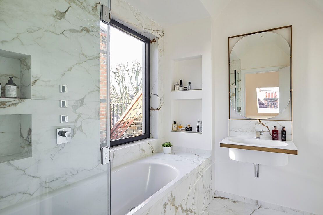 modern white  bathroom with cubby storage, bath tub and sink with mirror