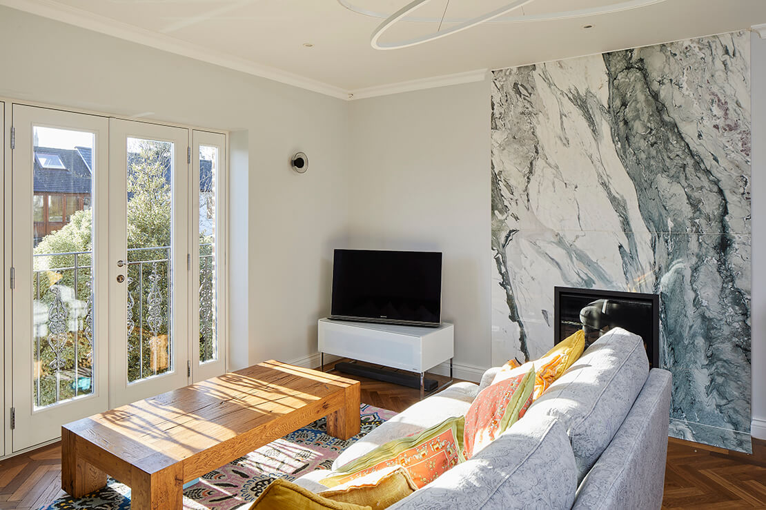 TV room with balcony and wooden flooring
