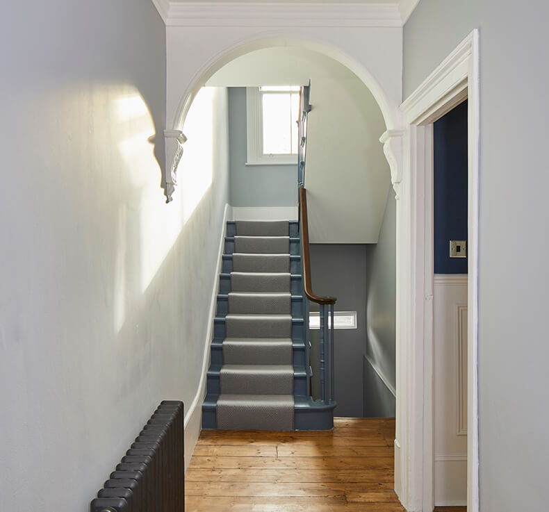hallway facing grey staircase