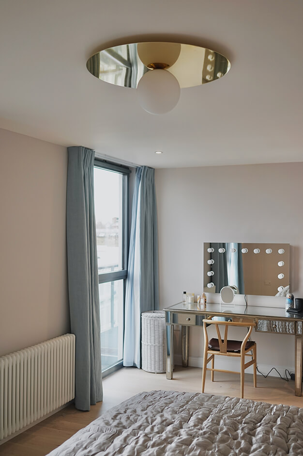bedroom with contemporary chandelier, radiator and LED mirror