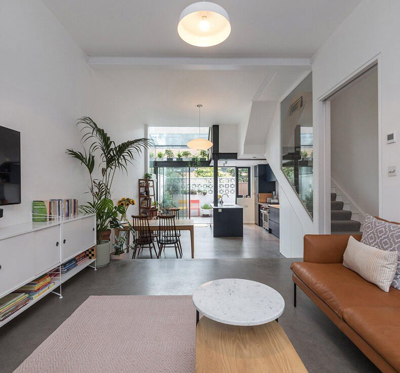 open plan lounge with small dining area and large kitchen