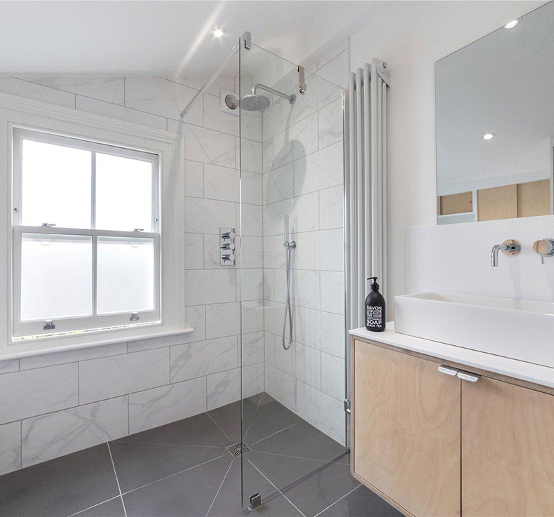 modern grey and white bathroom with fixed shower head and vessel sink