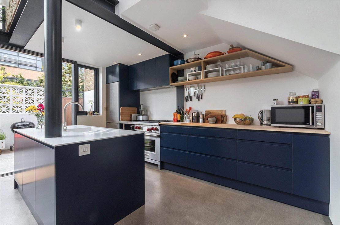 kitchen with blue cabinets and glass bifold doors