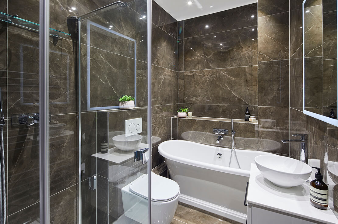 small tiled bathroom with shower, bath and toilet