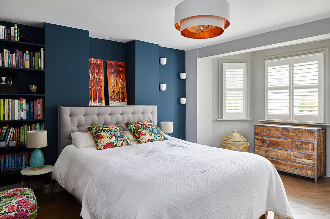 colourful bedroom with oak chest of drawers