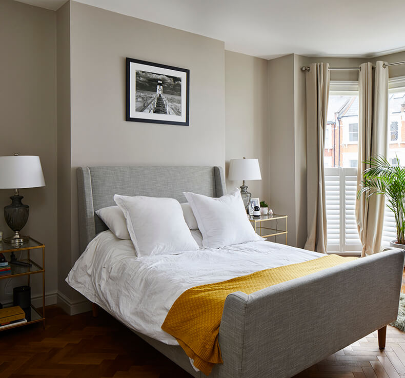 beige double bedroom with bedside table lamp