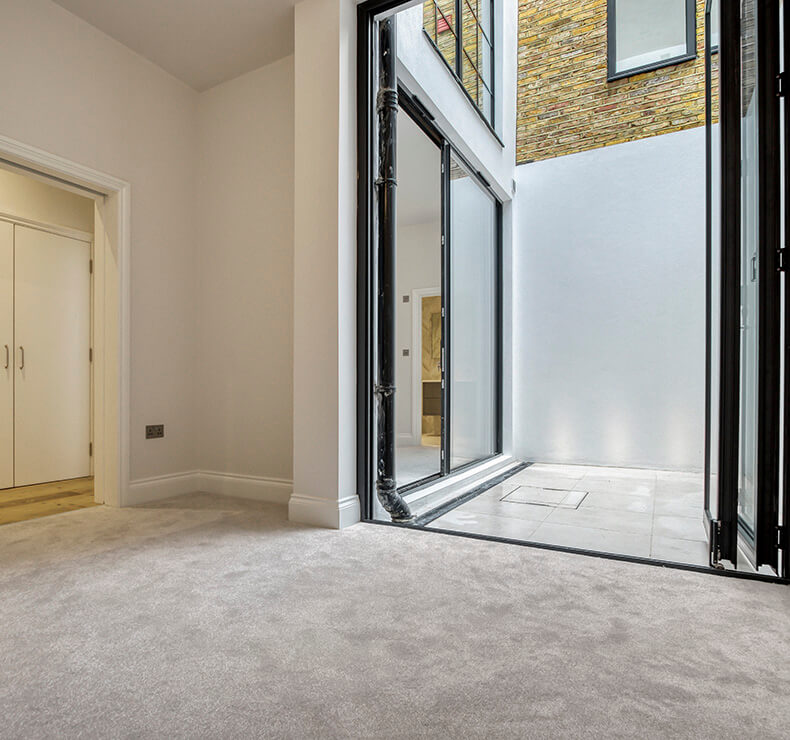 Modern empty bedroom room with bifold door, grey flooring.
