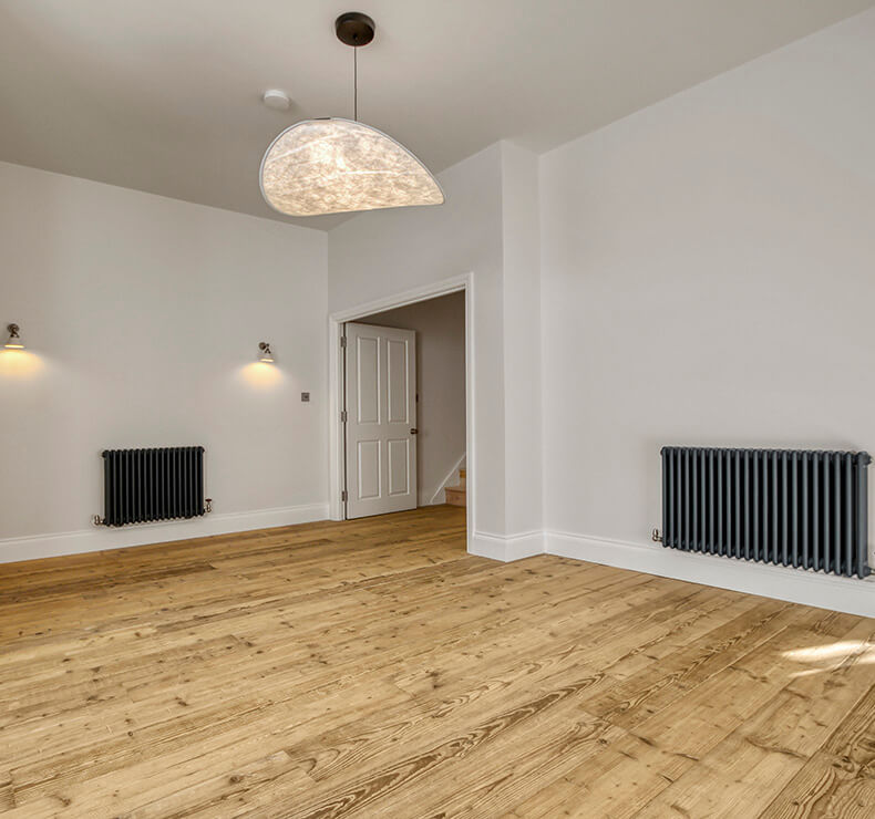 domestic room with modern design featuring light beige, chandelier and blue radiators.