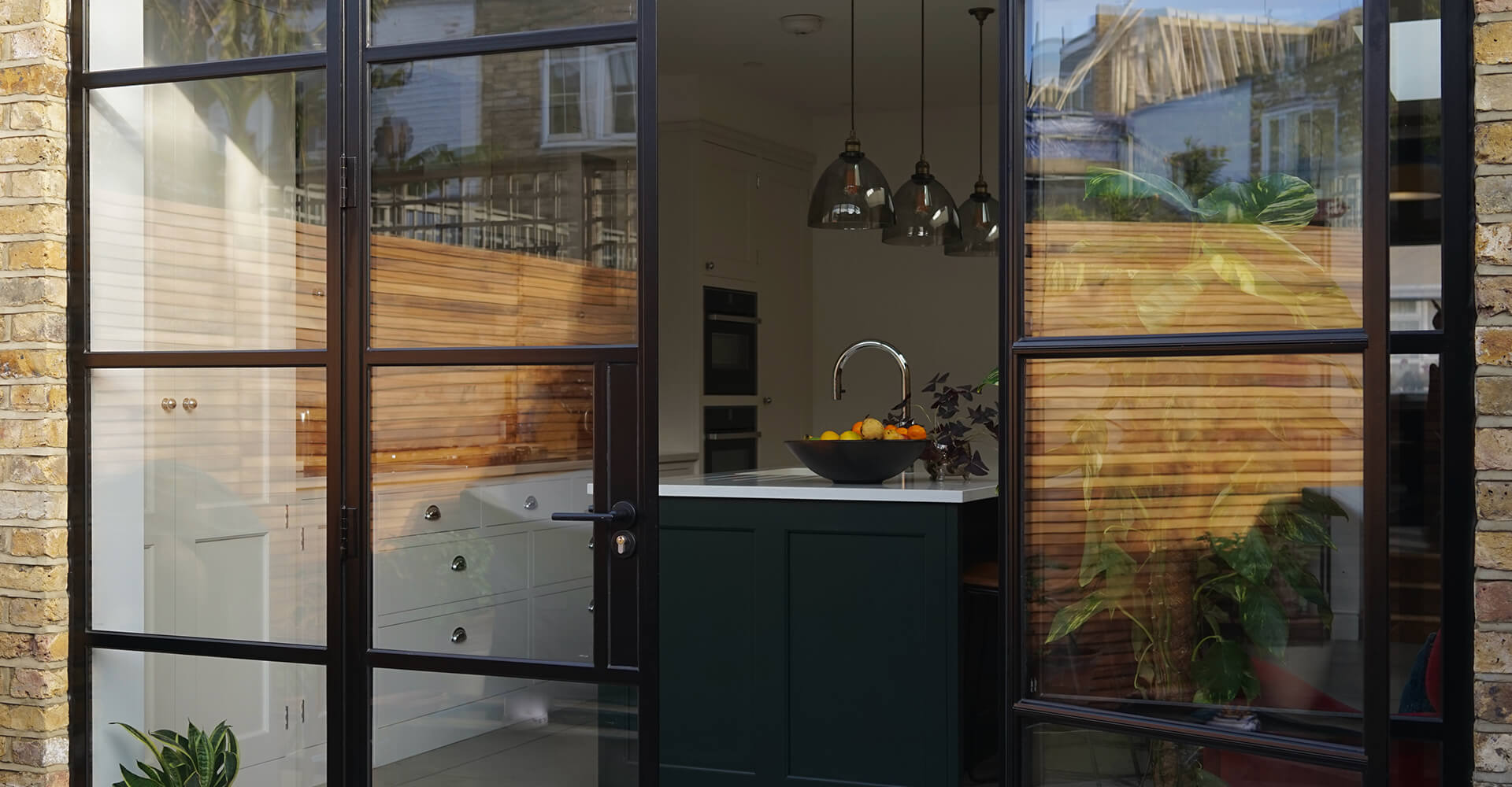 modern kitchen with white top island and garden view