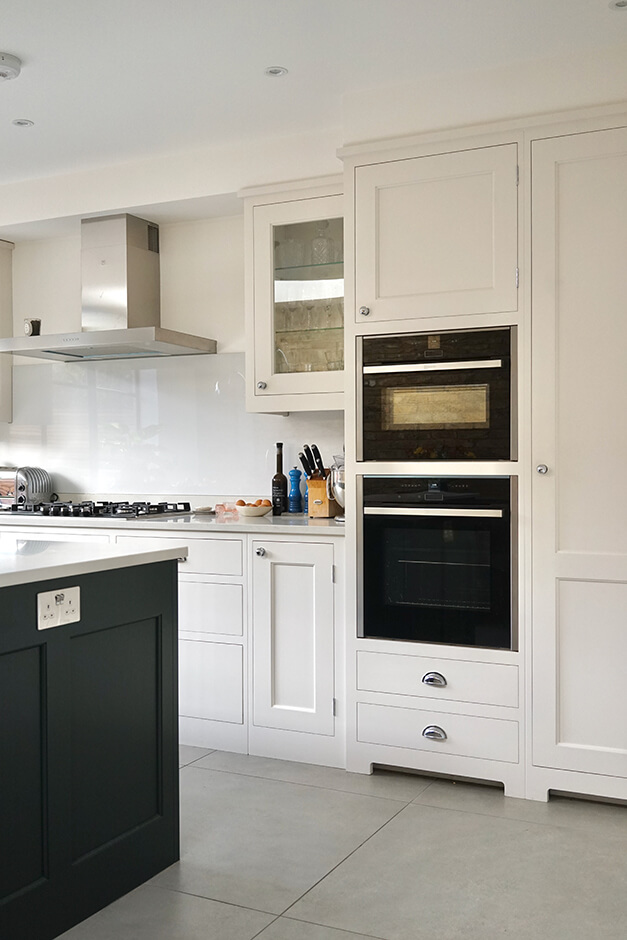 white kitchen cabinets with wall ovens and gas cook tops 