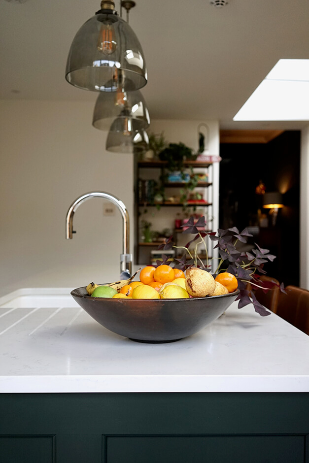 kitchen with white island, skylight and hanging lights