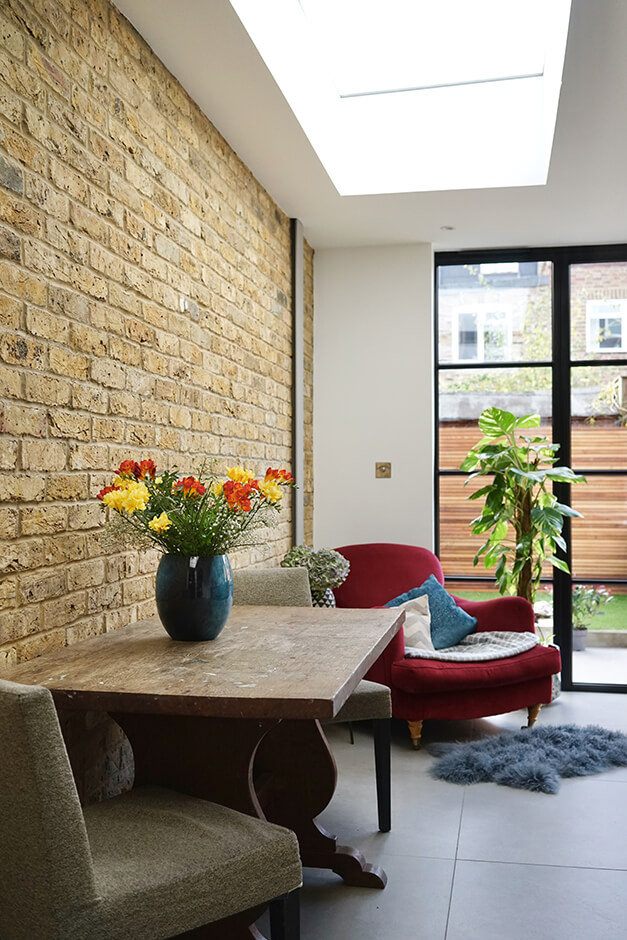 kitchen with skylight brick interior wall, skylight and garden view