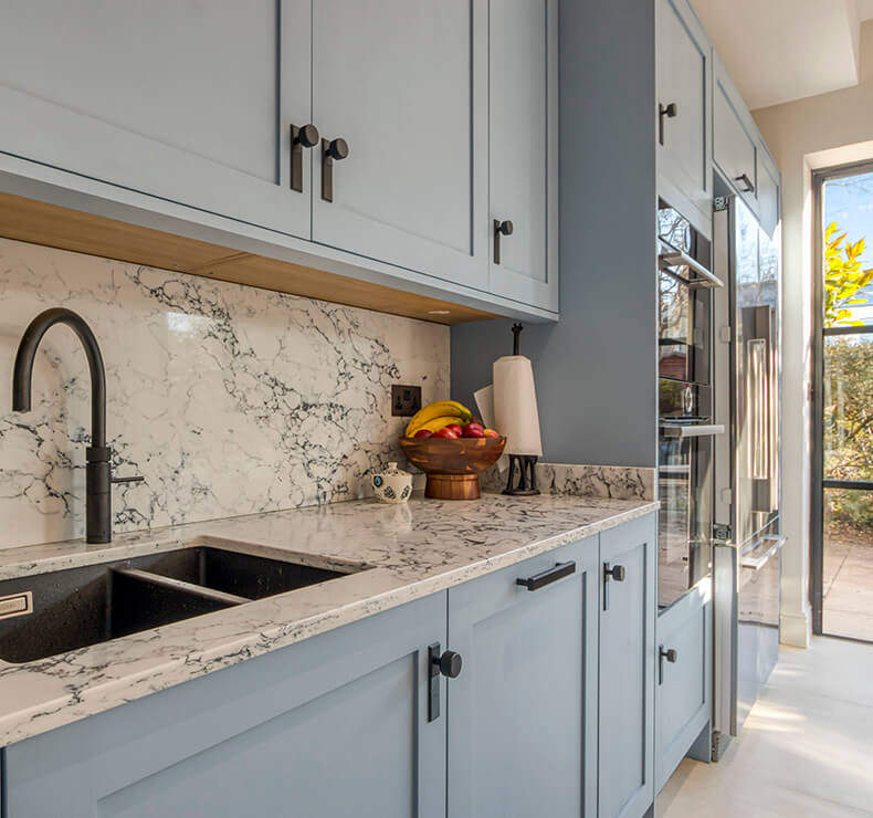 light blue kitchen cabinets with white countertop