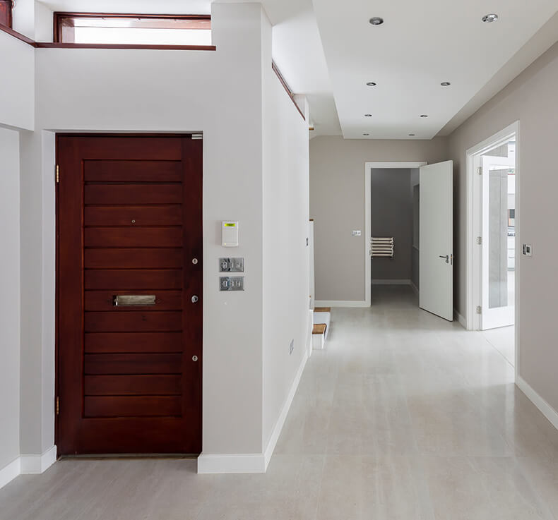 contemporary wooden door entrance to whit hallway
