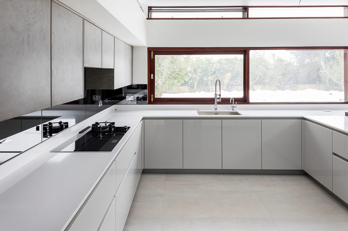 white u shape kitchen with a view to garden