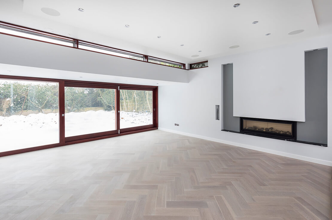 modern white living area with sliding glass doors and small fireplace