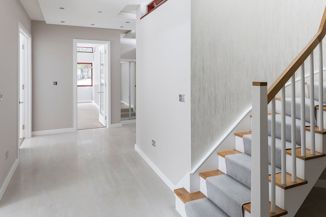 white hallway with stair leading upstairs