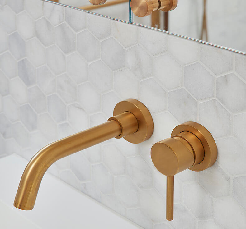 bathroom with gold faucet and mirror cabinet