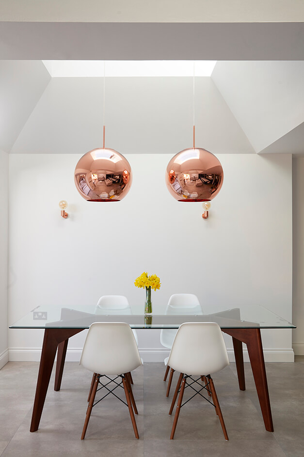 modern dining room with glass table and white chairs