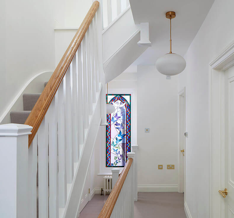 white staircase with carpeted stairs and white and wooden railing 