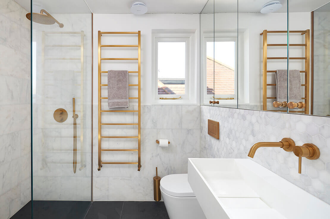 small white and grey modern bathroom with shower, toilet, sink and mirror cabinets