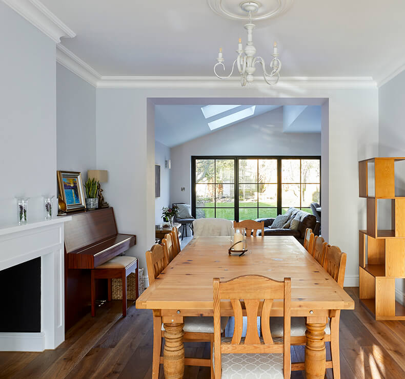 open plan dining room with piano and wooden dining set 