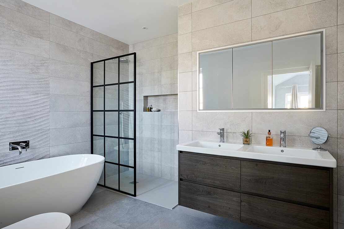 modern bathroom with tub, shower, mirror cabinets and dual sink