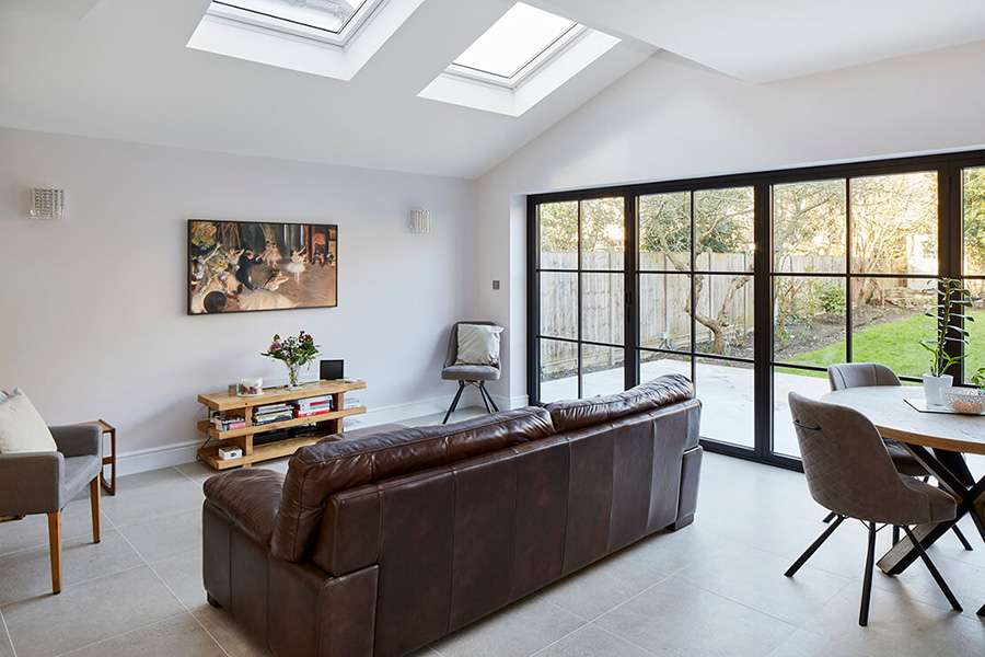 Modern open plan house extension with large windows and skylights