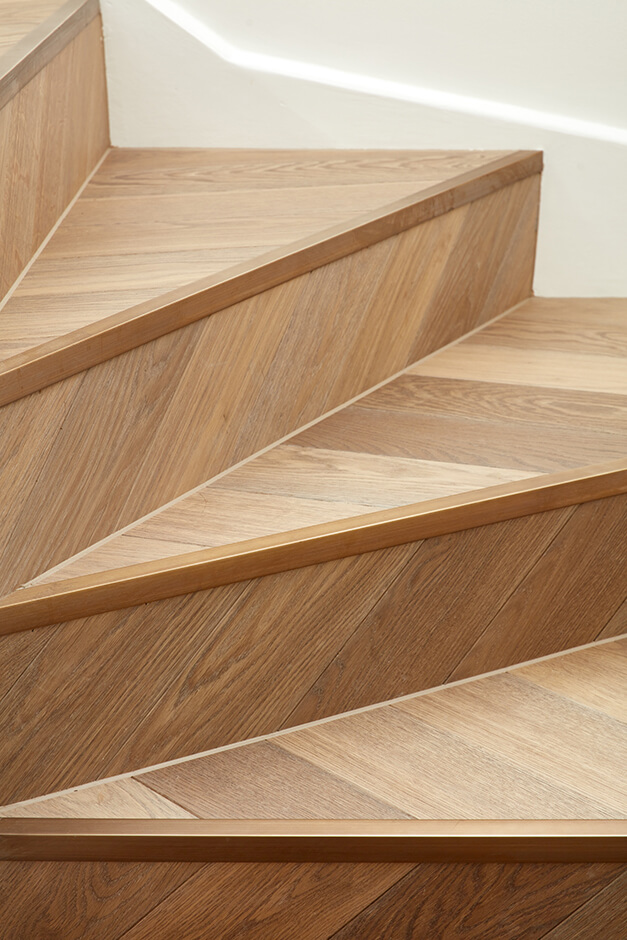 spiral staircase with modern wooden stairs and white walls