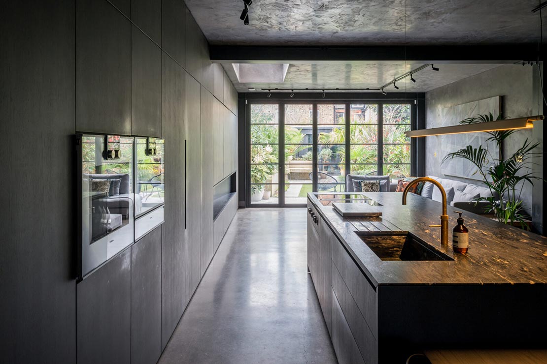 modern kitchen with grey cabinets and wall ovens