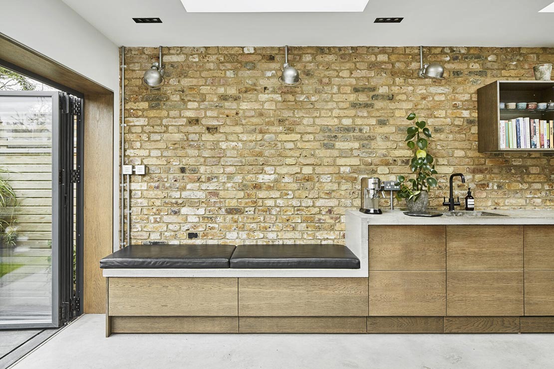 modern kitchen sitting area with exposed brick interior wall