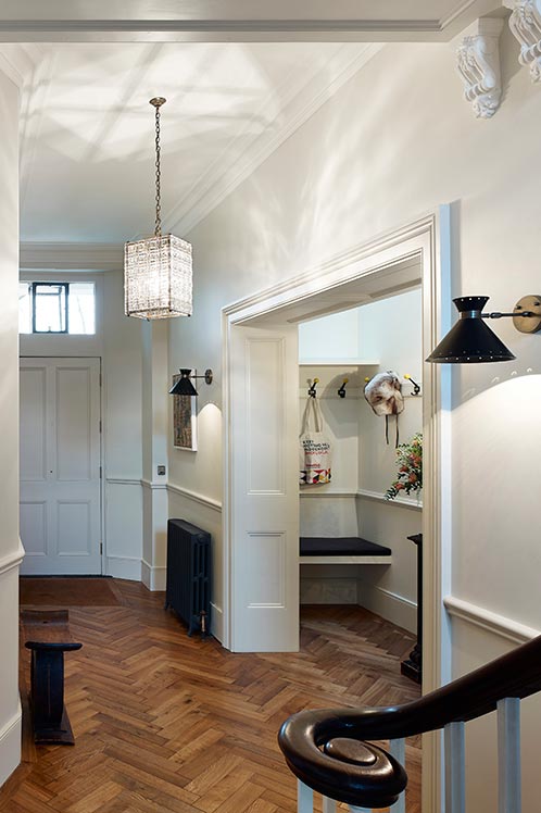 entrance with wooden flooring, radiator and hallway closet